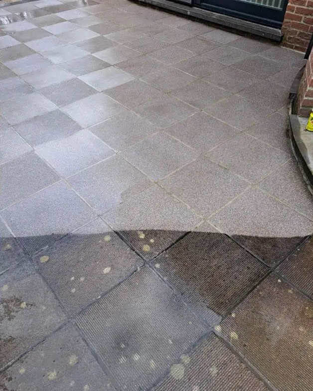 Terras halfweg de reiniging: bovenaan proper, onderaan nog vuil